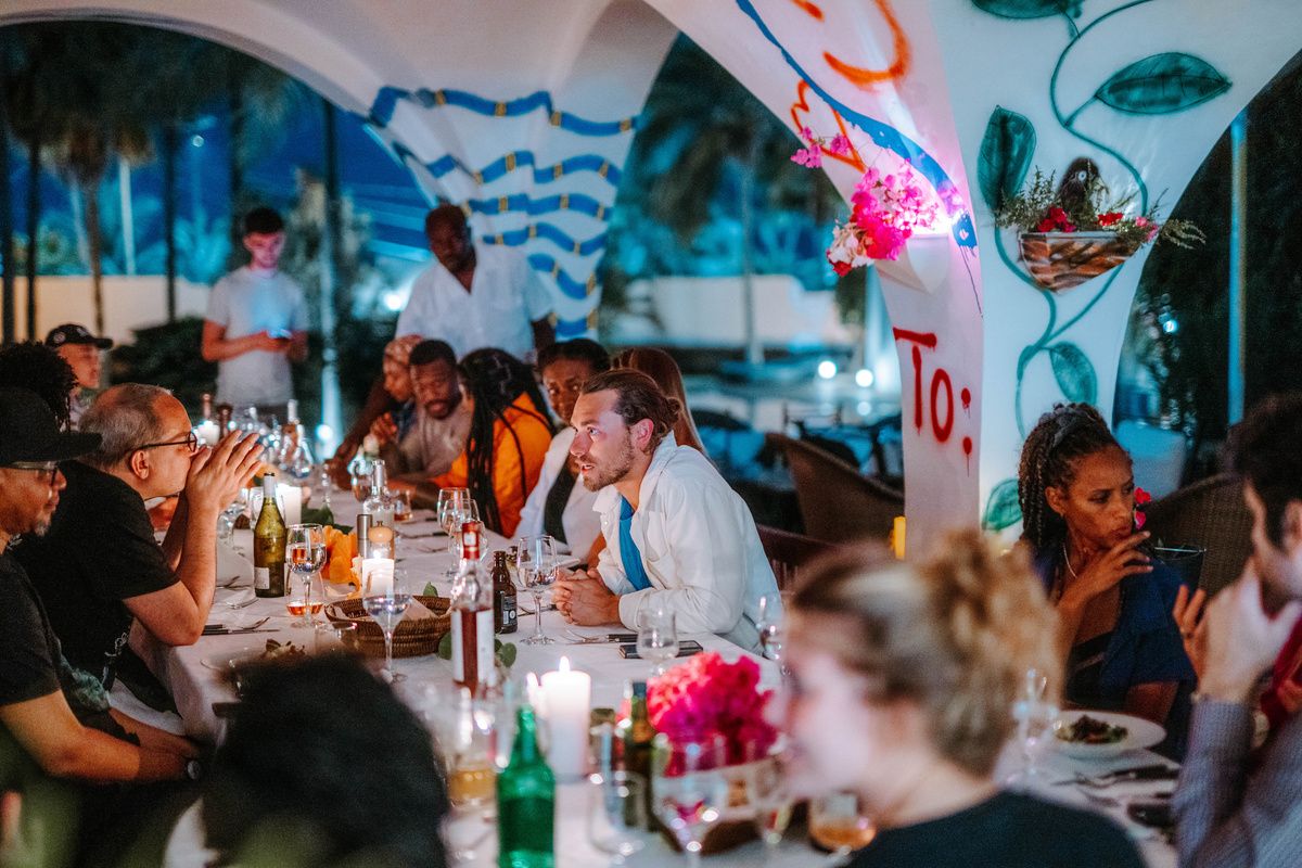 Candlelit dinner under white Moorish arches with pink flowers