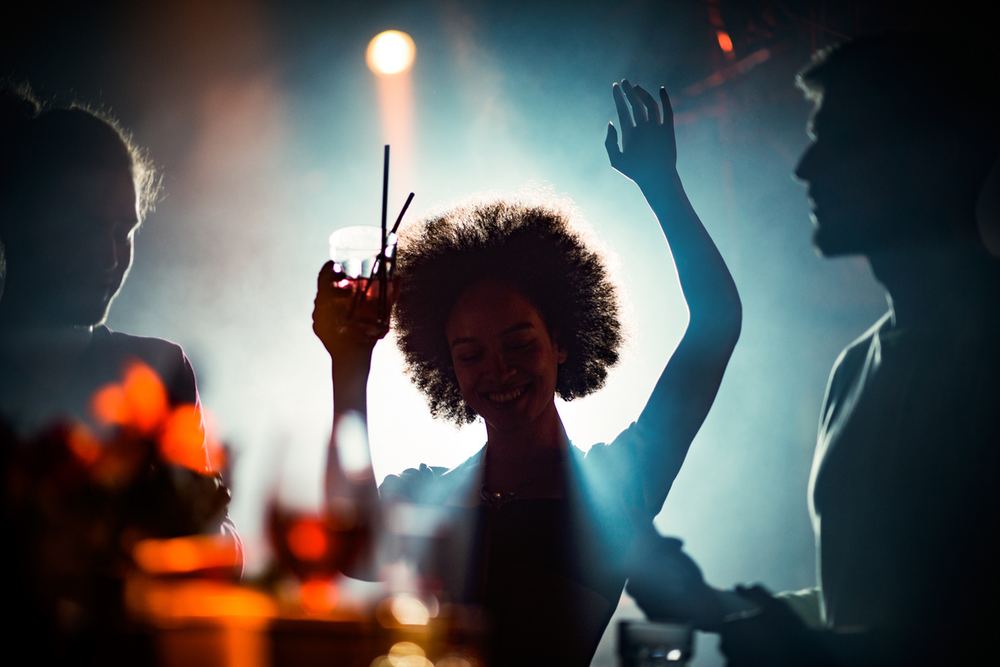 Guests dancing at an evening party with colourful lighting