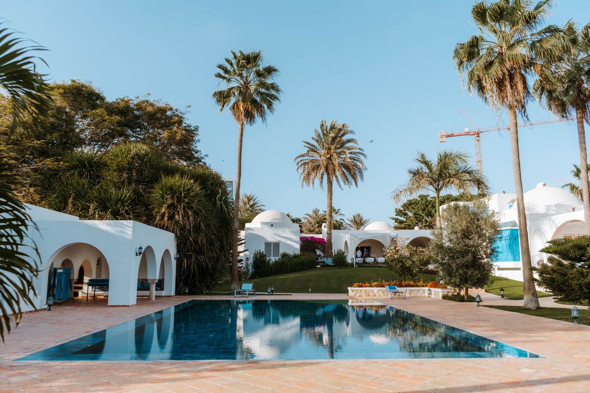 Villa pool surrounded by domed rooftops and palm trees